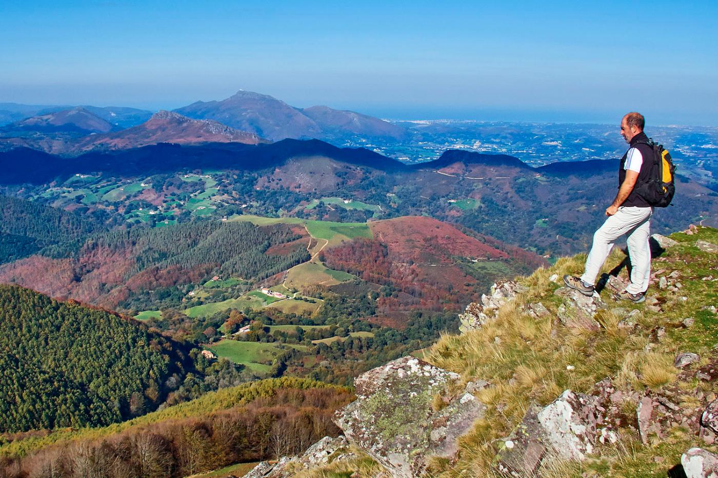 Man looking at the landscape from the mountain